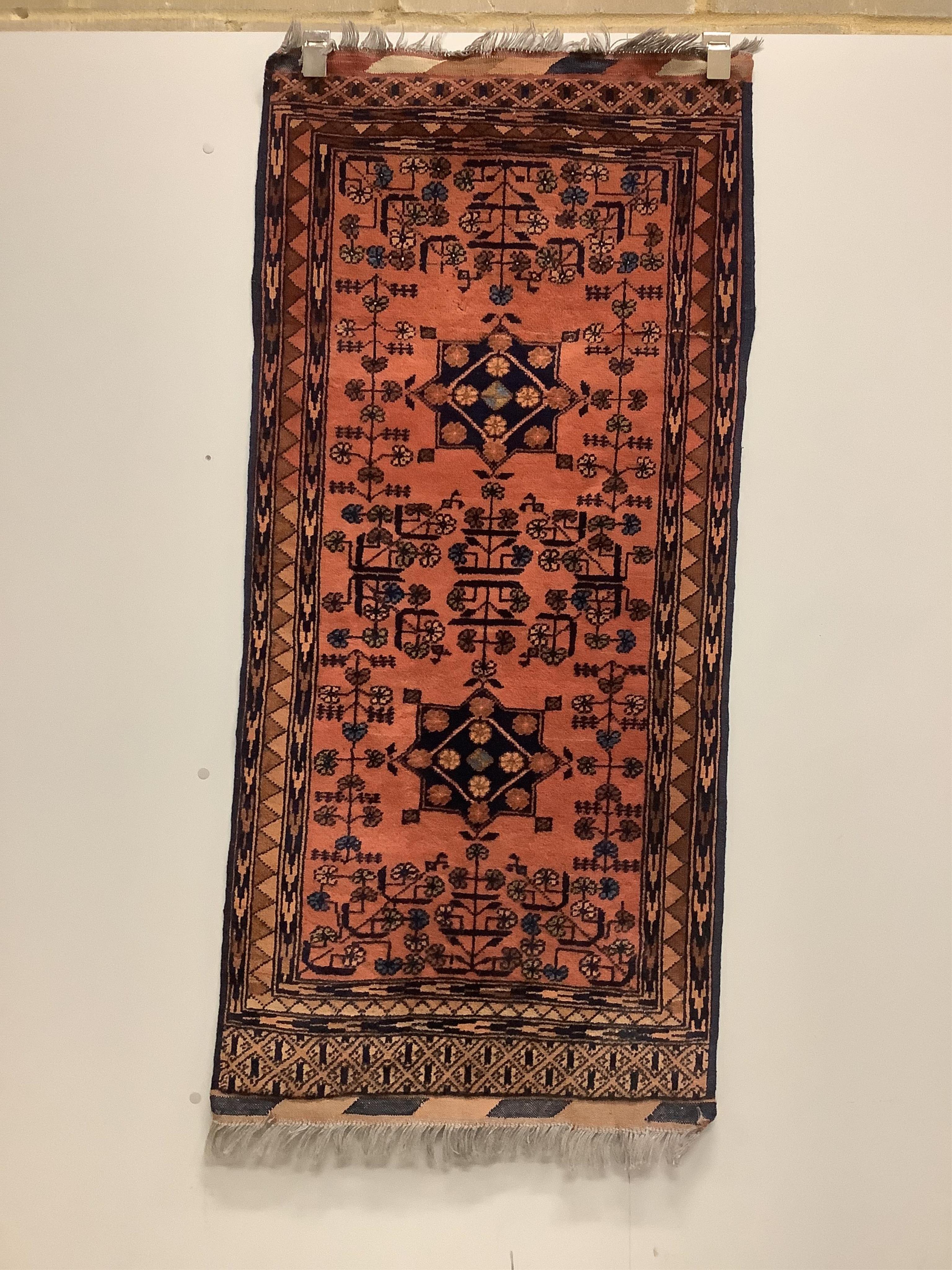 A Belouch red ground rug and a Bokhara rug, larger 180 x 106cm. Condition - fair